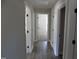 Hallway with wood-look floors and white doors at 104 Halifax Rd, Louisburg, NC 27549
