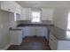 Modern kitchen featuring white cabinets and granite countertops at 104 Halifax Rd, Louisburg, NC 27549