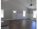 Spacious living area featuring wood-look floors, recessed lighting, and ample windows at 104 Halifax Rd, Louisburg, NC 27549