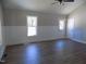Bright living room with wood-look flooring, wainscoting, and natural light at 104 Halifax Rd, Louisburg, NC 27549