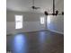 Open living room with wood-look floors, wainscoting, and natural light at 104 Halifax Rd, Louisburg, NC 27549