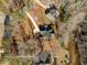 Overhead view of a neighborhood homes nestled among beautiful trees along the water at 1119 Sagamore Dr, Louisburg, NC 27549