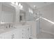Bright bathroom features a double vanity with white cabinetry and a glass-enclosed shower at 1119 Sagamore Dr, Louisburg, NC 27549