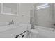 Bathroom with a tub/shower, mosaic tile floor, gray shower tile, and a white vanity at 1119 Sagamore Dr, Louisburg, NC 27549