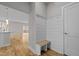 Entryway with wood floors, a shiplap wall with hooks and a bench, and doorway into living space at 1119 Sagamore Dr, Louisburg, NC 27549