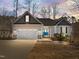 Charming single-story home with a two-car garage, blue door, and manicured landscaping at 1119 Sagamore Dr, Louisburg, NC 27549
