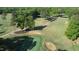 Scenic aerial view of the lush golf course, featuring manicured greens, sand traps, and tree-lined fairways at 1119 Sagamore Dr, Louisburg, NC 27549