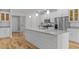 Bright white kitchen with a large island, stainless steel appliances and a pantry at 1119 Sagamore Dr, Louisburg, NC 27549