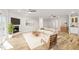 Bright living room featuring a fireplace, ceiling fans, and light wood floors at 1119 Sagamore Dr, Louisburg, NC 27549