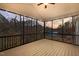 Relaxing screened porch with beautiful sunset views and a ceiling fan at 1119 Sagamore Dr, Louisburg, NC 27549