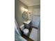 Updated bathroom with a modern vanity, circular mirror, and combined tub and shower with tiled walls at 1302 E Jones St, Raleigh, NC 27610