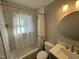 Well-lit bathroom with neutral-toned walls, updated vanity, and a combined tub and shower at 1302 E Jones St, Raleigh, NC 27610