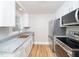 Modern kitchen with stainless steel appliances, granite countertops, and white cabinetry at 1302 E Jones St, Raleigh, NC 27610