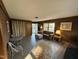 Cozy living room featuring wood paneled walls, tile floors, comfortable seating, and natural light at 1302 E Jones St, Raleigh, NC 27610
