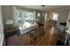 Inviting living room featuring hardwood floors, large windows, and an open layout to the dining area at 1302 E Jones St, Raleigh, NC 27610