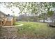 Expansive backyard with a walkway leading to a wooden deck, offering ample space for outdoor activities at 1508 Woods Creek Dr, Garner, NC 27529