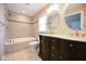 Bathroom featuring a tub with tile surround, double vanity, and oval mirrors at 1508 Woods Creek Dr, Garner, NC 27529