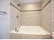 A close up of the tub features tile surround and updated faucet at 1508 Woods Creek Dr, Garner, NC 27529