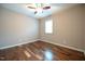 A bedroom with hardwood floors, ceiling fan, and a window at 1508 Woods Creek Dr, Garner, NC 27529
