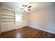 Bedroom with hardwood floors, ceiling fan, and built in shelves at 1508 Woods Creek Dr, Garner, NC 27529
