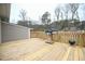 View of spacious wooden deck with railings and a grill, perfect for outdoor entertaining at 1508 Woods Creek Dr, Garner, NC 27529