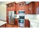 Modern kitchen features stainless steel appliances and granite countertops with hardwood flooring at 1508 Woods Creek Dr, Garner, NC 27529
