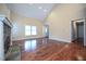 Inviting living room featuring hardwood floors, a stone fireplace, and ample natural light at 1508 Woods Creek Dr, Garner, NC 27529