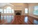 Spacious living room boasts a stone fireplace, hardwood floors, and large windows for natural light at 1508 Woods Creek Dr, Garner, NC 27529
