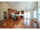 Spacious living room boasts a kitchen with an island, hardwood floors, and large windows at 1508 Woods Creek Dr, Garner, NC 27529