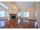 Bright, open living room featuring hardwood floors, a stone fireplace, and recessed lighting at 1508 Woods Creek Dr, Garner, NC 27529