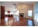 Bright living room featuring hardwood floors, stone fireplace, and views into the spacious open kitchen at 1508 Woods Creek Dr, Garner, NC 27529