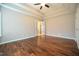 Primary bedroom featuring hardwood floors, a tray ceiling, and neutral wall colors at 1508 Woods Creek Dr, Garner, NC 27529