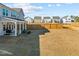 A large backyard with a covered patio, a wooden fence, and plenty of space for outdoor activities at 168 Begonia St, Angier, NC 27501