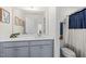 Well-lit bathroom featuring a stylish vanity with a gray cabinet and neutral countertops at 168 Begonia St, Angier, NC 27501