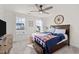 Cozy bedroom with a ceiling fan, natural light, and a decorative wooden wheel on the wall at 168 Begonia St, Angier, NC 27501