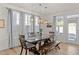 Bright dining area with a wooden table and bench seating near the back door at 168 Begonia St, Angier, NC 27501