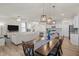 Spacious dining area with a large table, pendant lights, and access to the kitchen at 168 Begonia St, Angier, NC 27501