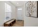 Entryway featuring wood floors, a large window, and a bench with storage underneath for shoes at 168 Begonia St, Angier, NC 27501