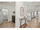 Hallway featuring wood floors, a console table, a mirror, and access to the bathroom and living room at 168 Begonia St, Angier, NC 27501