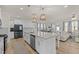 Modern kitchen with large island, stainless steel appliances and view into living room at 168 Begonia St, Angier, NC 27501