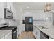 Modern kitchen with granite countertops, stainless steel appliances, and white shaker cabinets at 168 Begonia St, Angier, NC 27501