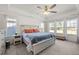 Spacious main bedroom with a large bed, plenty of natural light, and a ceiling fan at 168 Begonia St, Angier, NC 27501