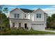Two-story farmhouse-style home with white siding, stone accents, and a two-car garage at 2012 Clydner Dr, Apex, NC 27523