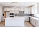 Modern kitchen with white cabinetry, island, and a linear light fixture at 2012 Clydner Dr, Apex, NC 27523