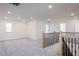 Open loft area with neutral carpeting and railing at 2012 Clydner Dr, Apex, NC 27523