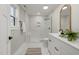 Modern bathroom with marble shower, double vanity, and arched mirrors at 2207 Edwin Ave, Durham, NC 27705