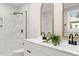 Bathroom with double vanity, marble shower, and arched mirrors at 2207 Edwin Ave, Durham, NC 27705