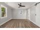 Spacious bedroom featuring two windows, ceiling fan, and wood-look flooring at 2207 Edwin Ave, Durham, NC 27705