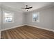 Bright bedroom with two windows and wood-look flooring at 2207 Edwin Ave, Durham, NC 27705