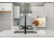 Close-up of the new kitchen with island, modern appliances, and neutral backsplash at 2207 Edwin Ave, Durham, NC 27705